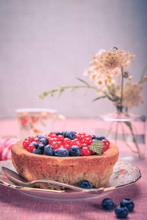 still life with blueberries and red currant on the rural style tableの写真素材