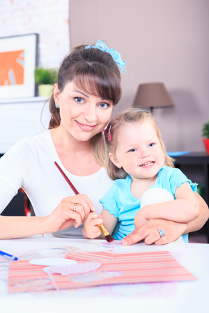 mother and her little daughters tinker gifts at homeの写真素材