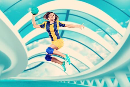 female handball player with a ball on the fieldの写真素材