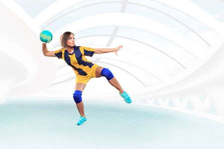 female handball player with a ball on the fieldの写真素材