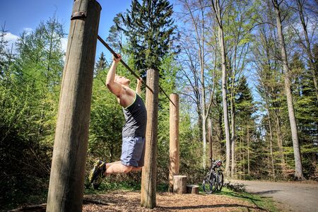 young man at training on a fitness trail