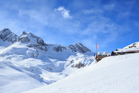 LECH, AUSTRIA - CIRCA FEBRUARY 16: The unidentified ski driver and snowboarder on the piste in Alps...