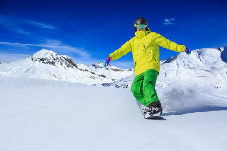 A snowboarder on the piste in Alps in Austriaの写真素材