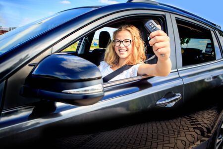 a young girl after successfully driving exam in a car