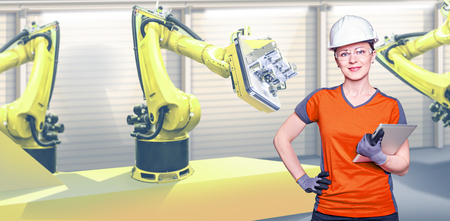 A young female technician while machine constructing in a manufacturing plantの写真素材