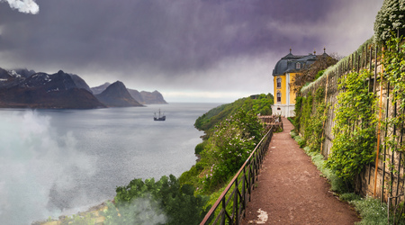 fantasy coastal landscape of an unreal Land with a castle and sailing shipのeditorial素材