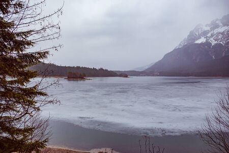 The Lake Eibsee in Alps at rain weather in spring, Garmisch-Partenkirchen, Germany