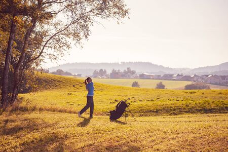 female golf player with a golf clubの写真素材
