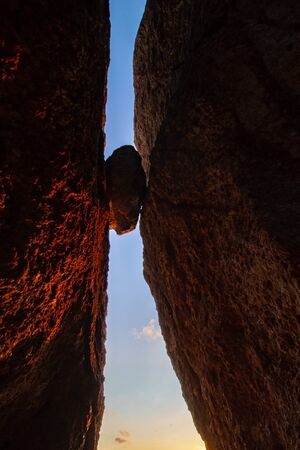 silhouette of rock stuck between two rocks 2
