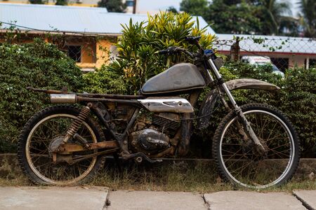 Old dirty mortobike on the street of vang viengの写真素材