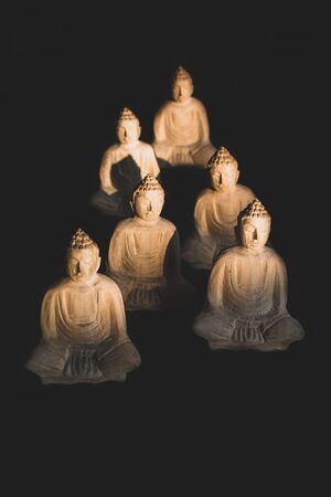 Pyramid of little wooden buddha statues meditating