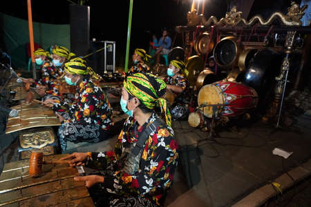 Central Javanese traditional music player, Indonesian "gamelan", playing music to accompany the performance.のeditorial素材