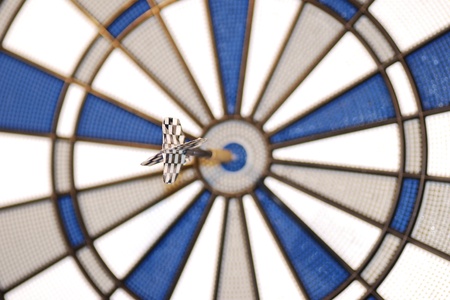 blue arrow hits right in the middle bullseyeの写真素材