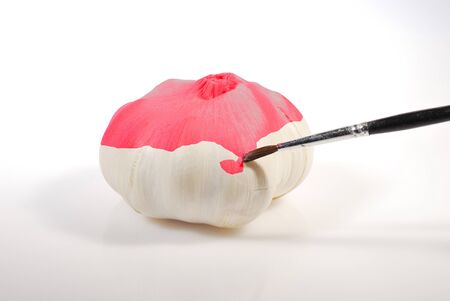 a white garlic painted with red colorの写真素材