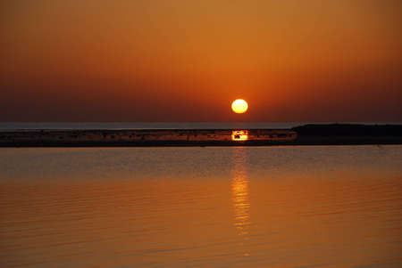 warm sunrise on the sea and beach in the summer holidayの写真素材