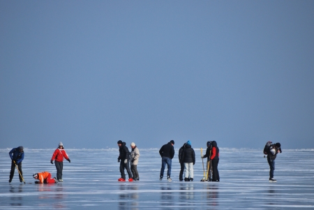 skating on the frozen lake in many people with winter blue skyのeditorial素材
