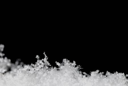 Small white background with black snow crystals in the winter flatの写真素材