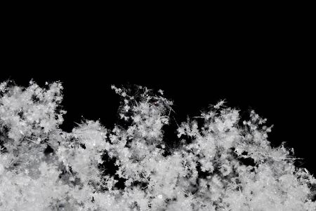Small white background with black snow crystals in the winter looseの写真素材