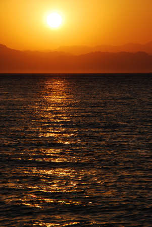 Sunrise on the sea with mountains in aegypten portraitの写真素材