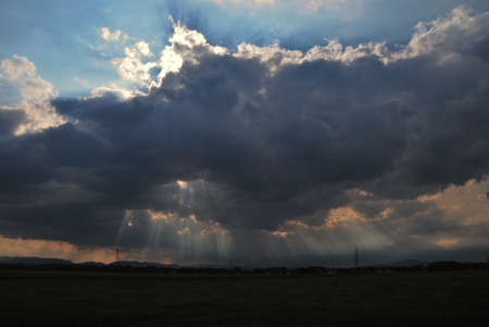 many sun rays appear from dark clouds
