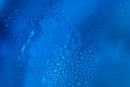 grease on the surface in blue waterの写真素材