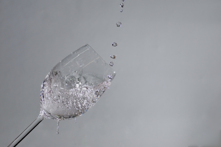 sparkling drops in water and wine glassの写真素材