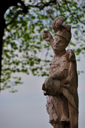 statue made   of stone with a treeの写真素材