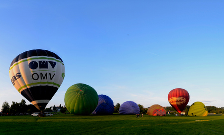 beautiful colorful balloons standing or lying on a meadow panorama during the dayのeditorial素材