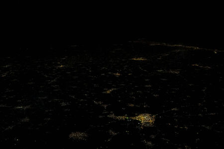 lighting of a city at night from the planeの写真素材