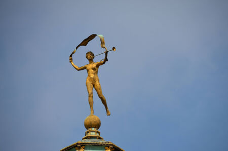 golden figure on a roof in londonの写真素材
