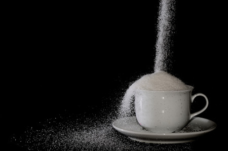 white cup with sugar goes onの写真素材