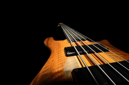 bass guitar strings with wooden close up black backgroundの写真素材
