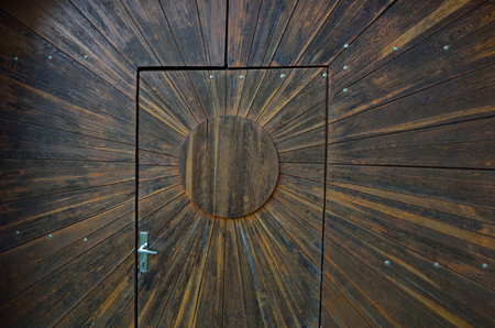 door in a wall made ??of brown woodの写真素材