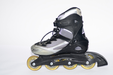 rollerskates in gray and black on white background close-upの写真素材