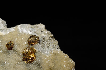 golden pyrite balls on calcite