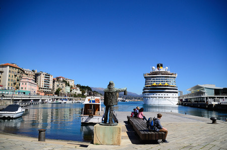 large statue and huge cruise ship in the port of Savonaのeditorial素材