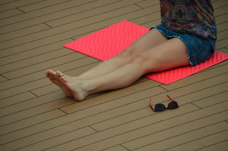 woman with miniskirt in gymnastics on a cruise shipの写真素材