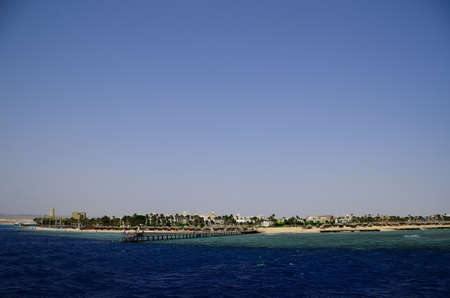 big beautiful hotel area with a jetty and palm trees in Egypt