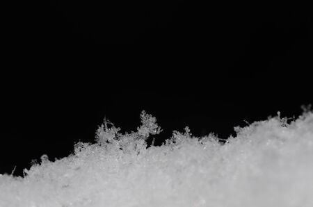 fresh loose snow on black backgroundの写真素材