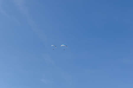 two paragliders on blue skyの写真素材