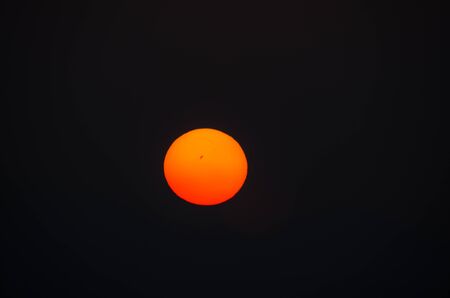 orange big sun on a black backgroundの写真素材