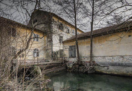 abandoned old houses with creekの写真素材
