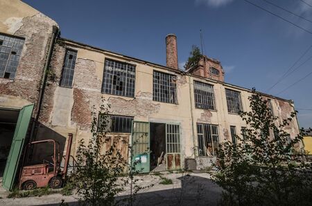 abandoned old factory grounds with a forkliftの写真素材