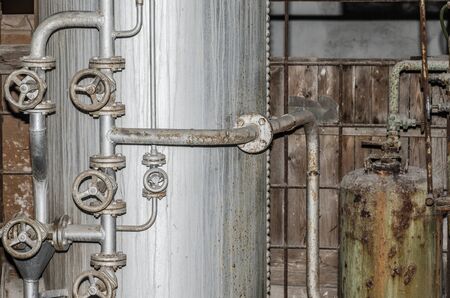 boiler and many pipes in an old factoryの写真素材