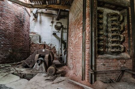 many rusty pipes in an old factory roomの写真素材
