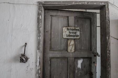 inscription with high voltage on a wooden doorの写真素材