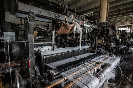 threads on a machine in an abandoned spinningの写真素材