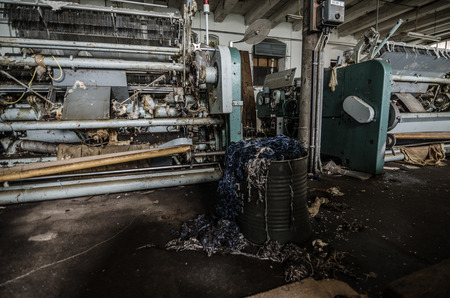 machines with yarn waste in an old factoryの写真素材