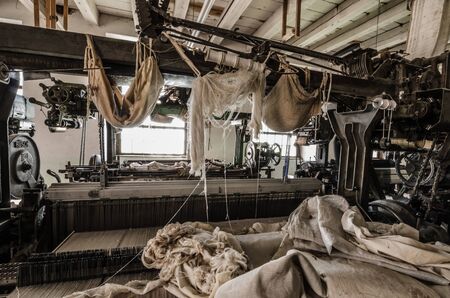 many fabrics on machines in old spinning factoryの写真素材