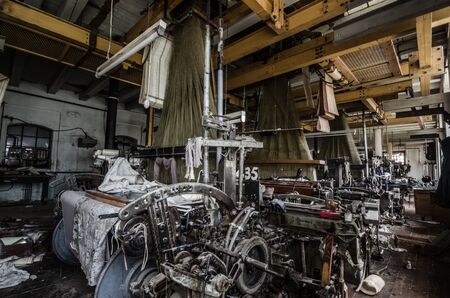 many old machines in abandoned spinning factoryの写真素材